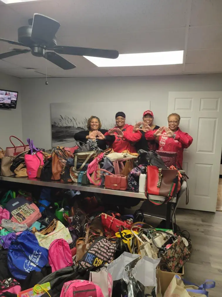 Group of people in a room full of bags